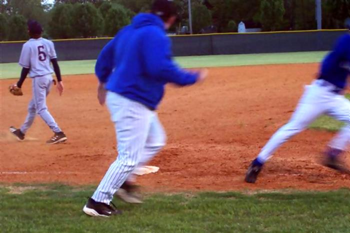 Coach Norval waving a runner home.