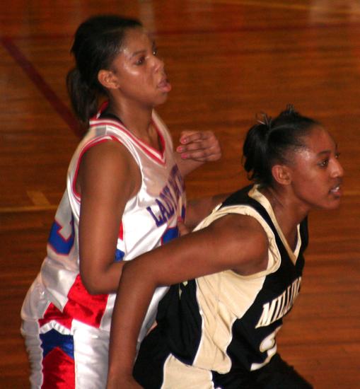 Spencer holds off Bartlett's Ashley Herring in the post.