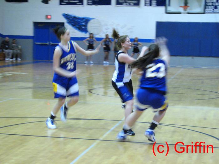 Erika Mathes (white) makes a clear pass