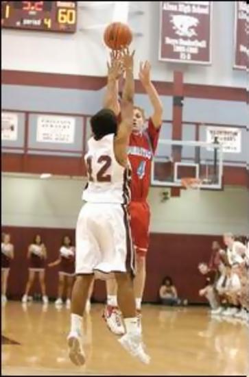 Heritage's Michael Haynes puts up the game winner over Alcoa's Brian Sommer.