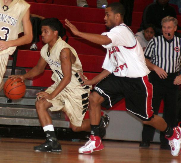 Trojan guard Trey Woods heads up court.