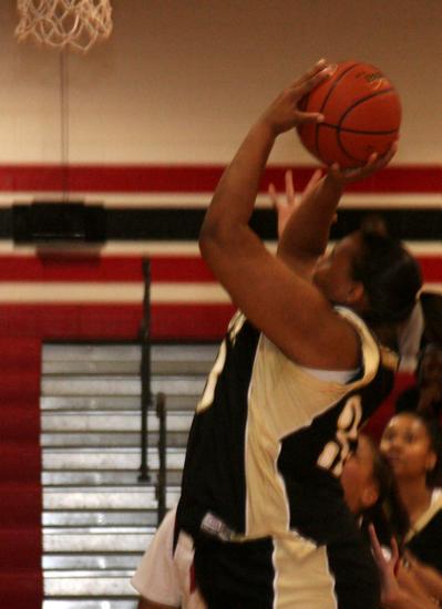 Lady Trojan Sabrina Mathews goes up to the basket.