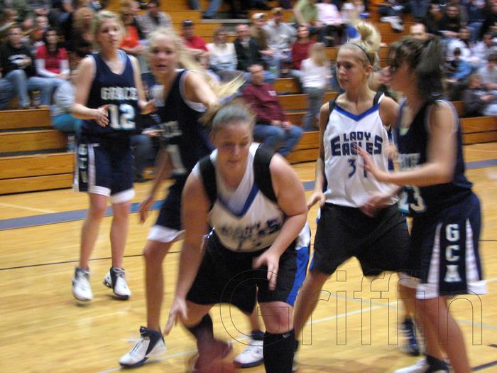 Kalsea Mantooth (white 12) drives under the basket
