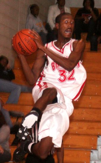 Burns in mid-air looking for an open teammate.