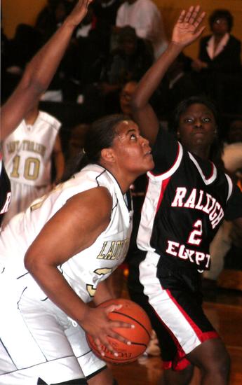 Lady Trojan senior Sabrina Mathews scores two of her six points in the second quarter.